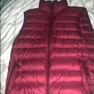 a burgundy polo vest